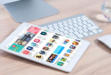 A white tablet with the app store opened on the screen